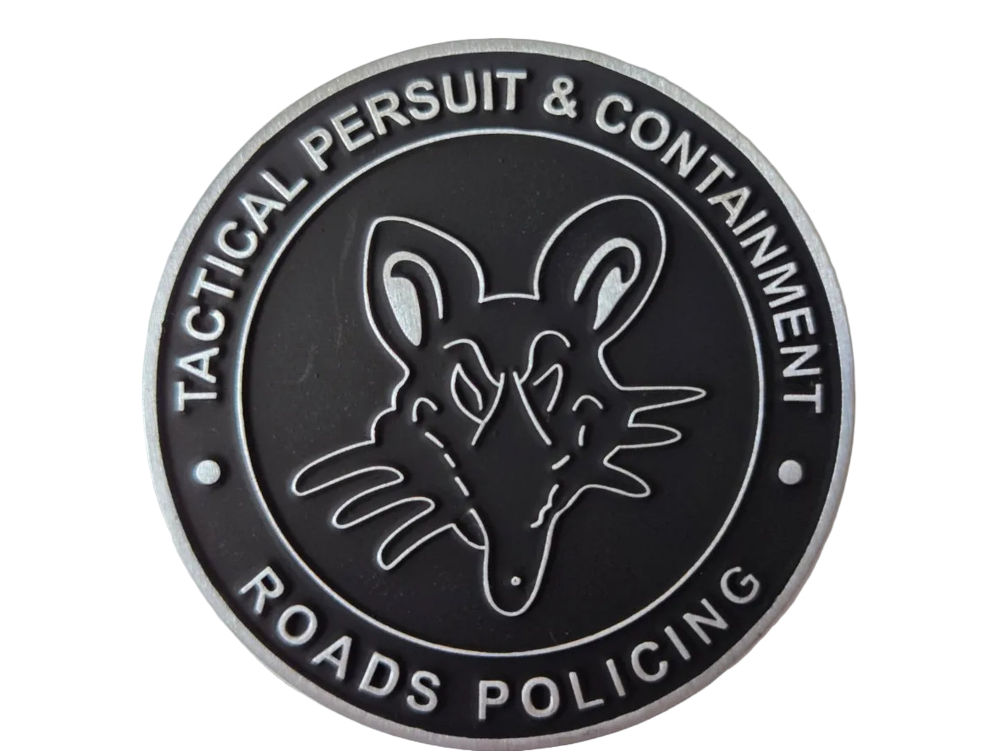 A circular black and silver tactical patch featuring a stylized mouse head emblem in the center, with the text 'TACTICAL PERSUIT & CONTAINMENT' and 'ROADS POLICING' around the border.